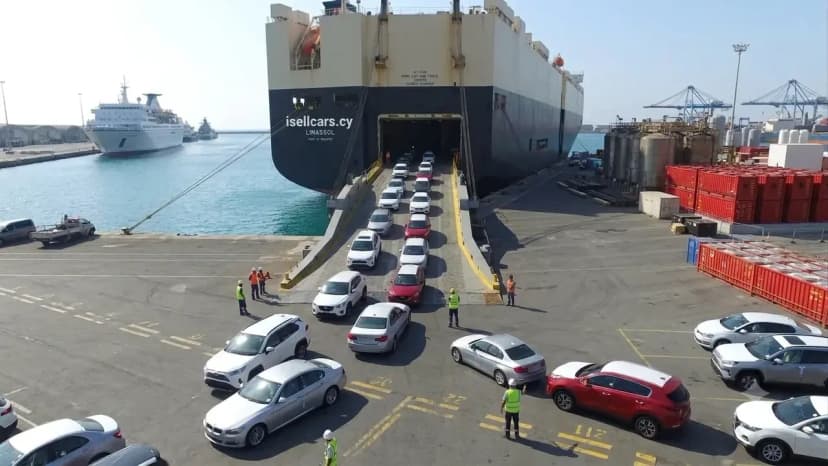 An isellcars.cy named Ro-Ro unloading vehicles in the port of Limassol.