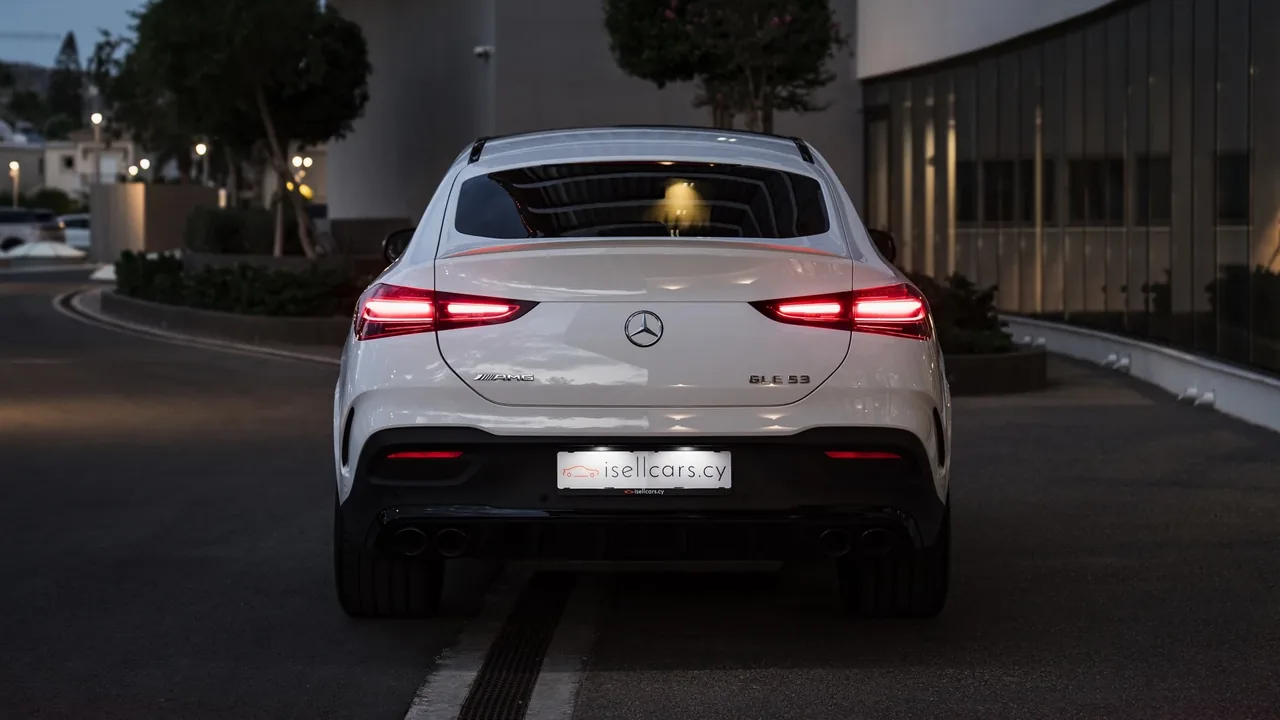 Rear view on an evening street with the tail lights on. Car 96