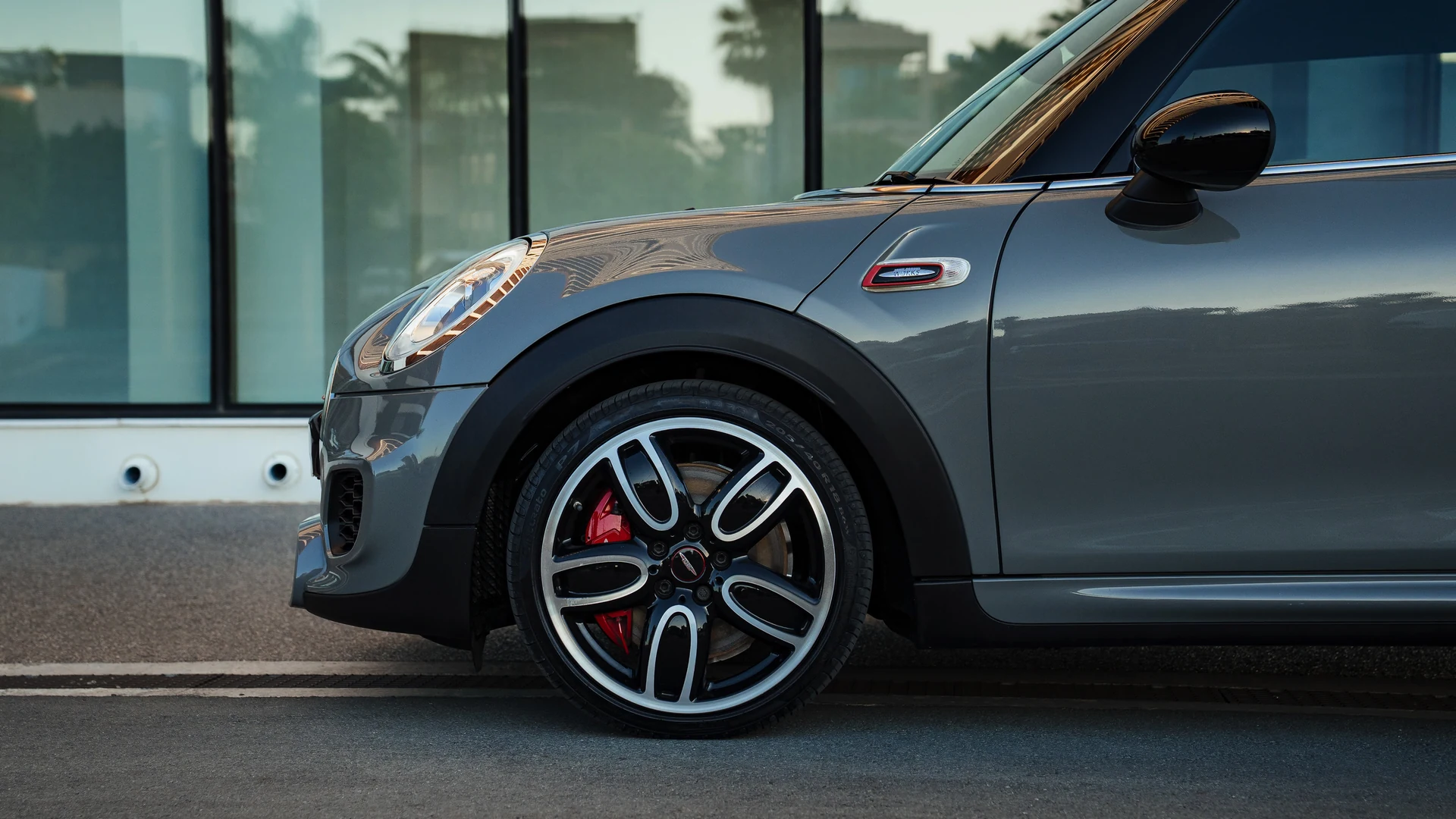 Grey Mini John Cooper Works front wheel and red brake caliper detail. Car 78