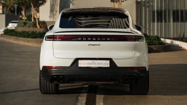 Rear three-quarter, coupe roofline and gloss black upper wing. Car 79