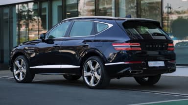Rear three-quarter view, Capri Blue, full-width tail light bar. Car 80