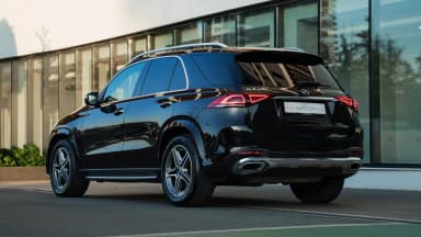 Rear three-quarter exterior view of the black SUV showing the roofline and tail lights. Car 86
