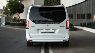 Rear exterior view showing the tailgate and full-width tail light bar. Car 84