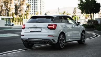 Rear three-quarter view on a city street. Car 87