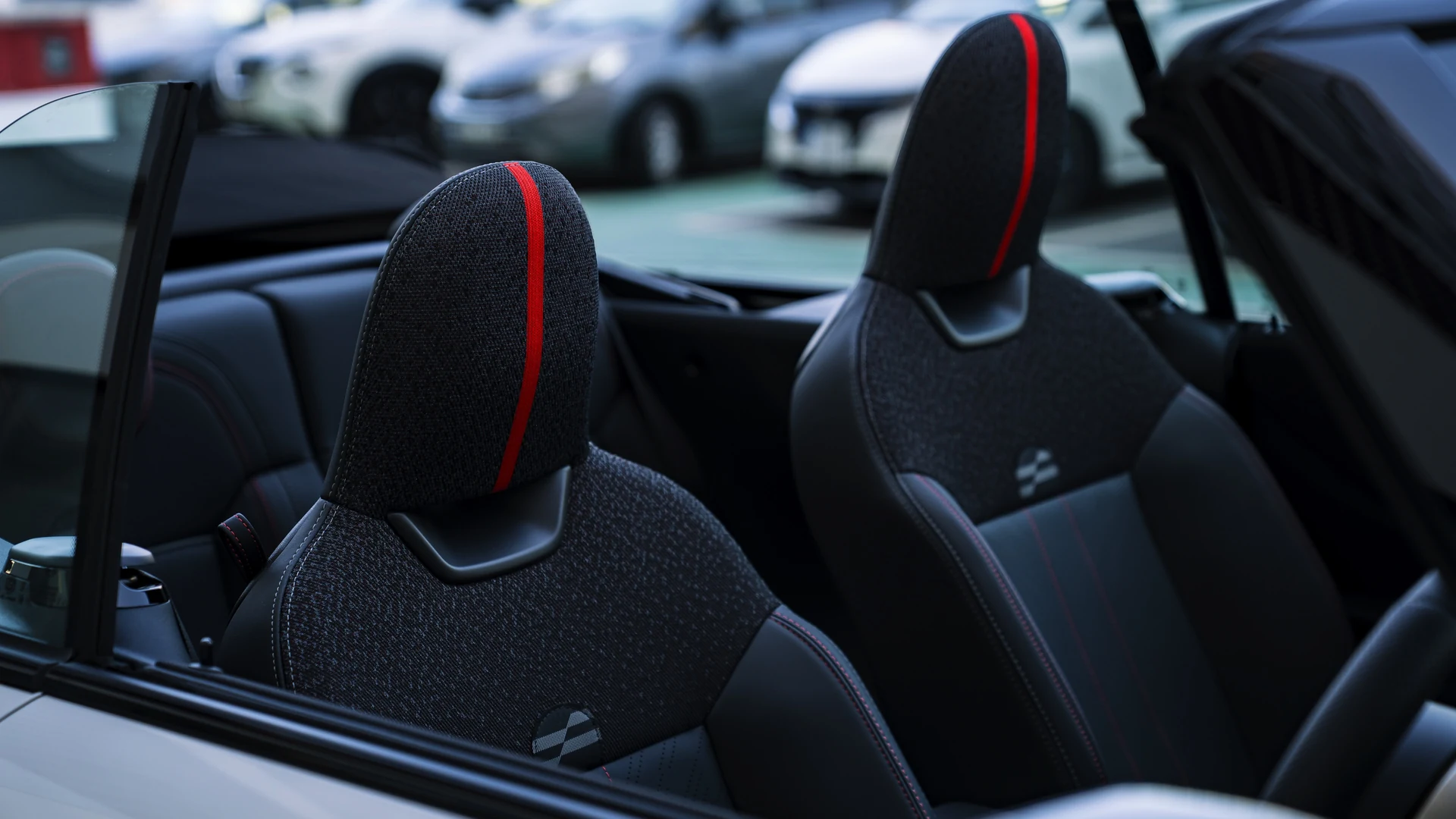 Front sport seat detail, bolster and red contrast stitching. Car 81