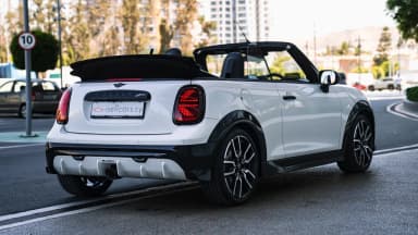 Rear three-quarter opposite side, roof down, convertible profile. Car 81