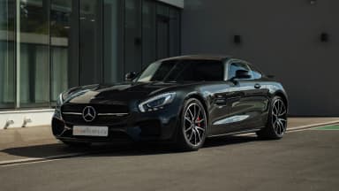 Black car, front three-quarter exterior view. Car 77