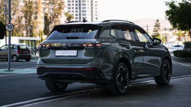 Rear three-quarter opposite side, urban setting. Car 82