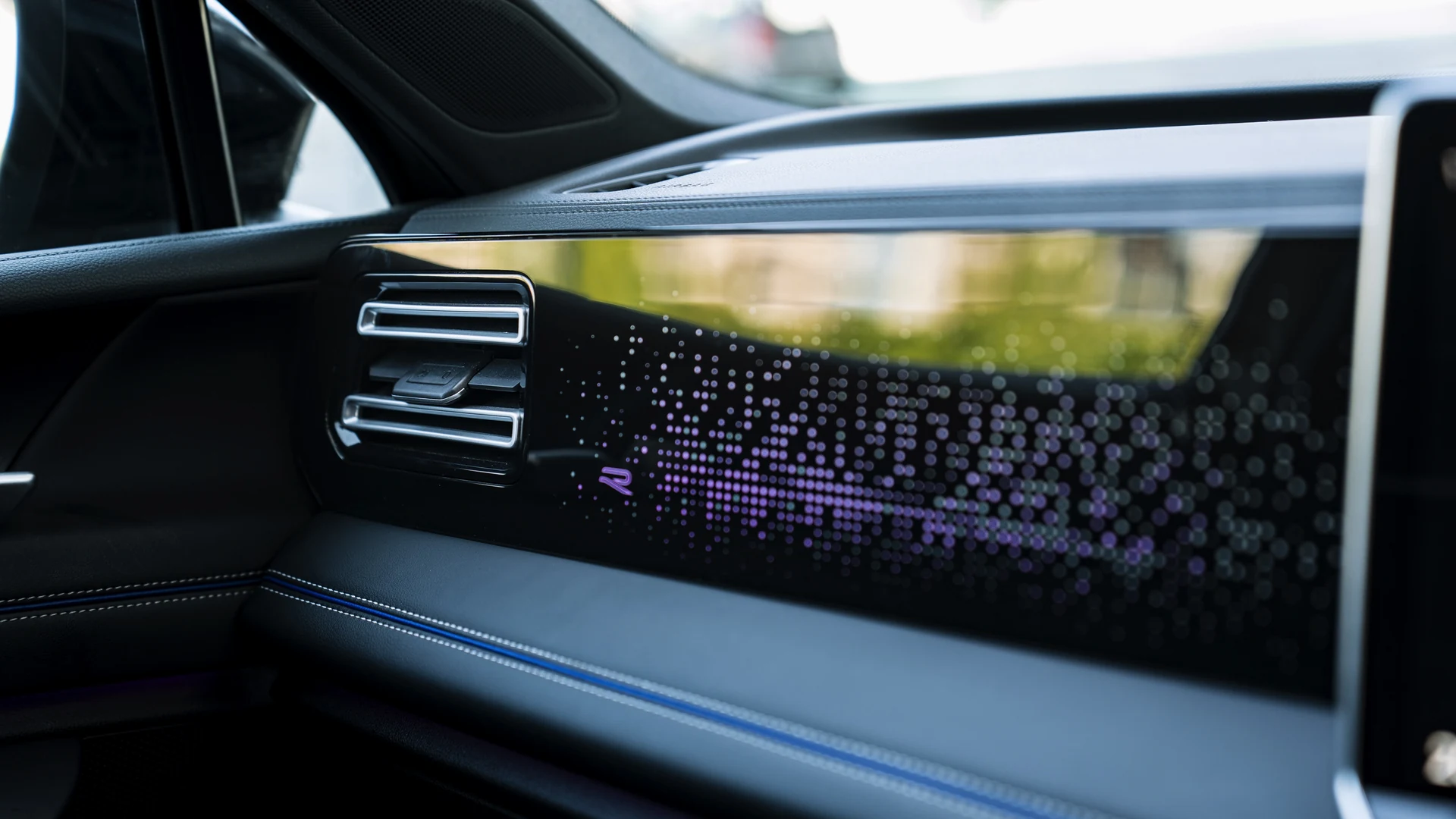 Dashboard ambient lighting, air vent detail. Car 82
