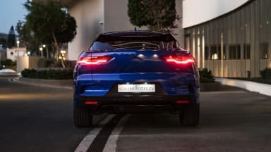 Rear view with the tail lights illuminated and model badge. Car 88