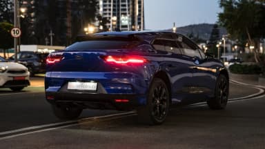 Rear three-quarter view on a city street in evening light. Car 88
