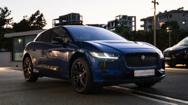Front three-quarter view against an urban backdrop at dusk. Car 88