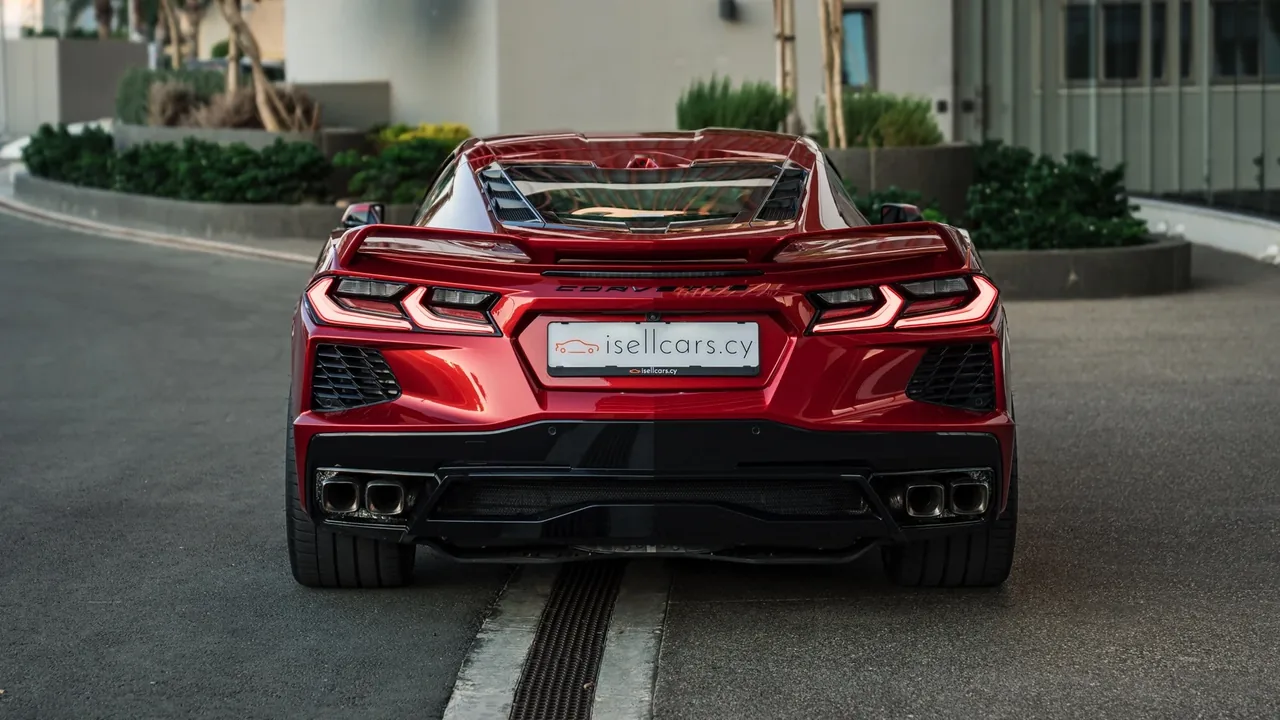 Direct rear view with twin-element taillights and black diffuser. Car 94
