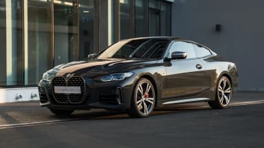 Front three-quarter view of a black 2021 BMW 440i xDrive in Cyprus. Car 90
