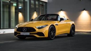 Front three-quarter view of a yellow 2023 Mercedes-AMG SL 43 in Cyprus. Car 91