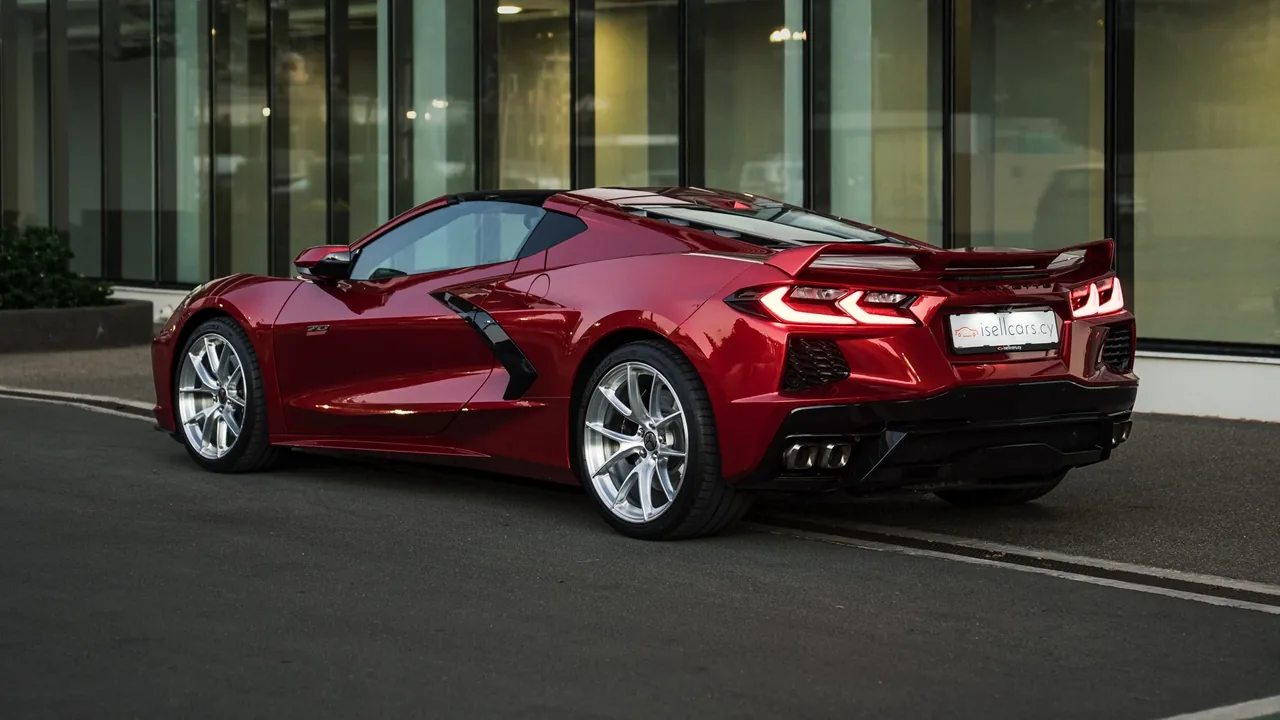 Rear three-quarter view with high rear spoiler and quad exhaust tips. Car 94