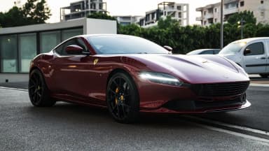 Front three-quarter view against an urban backdrop. Car 92